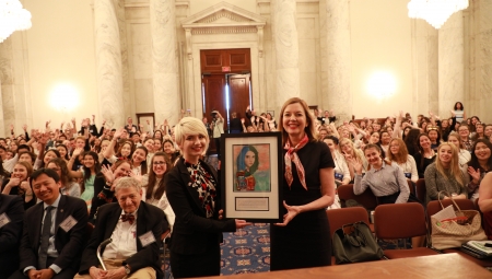 Lea Bagi (left), from Serbia, presented Assistant Secretary Marie Royce (right), of the Bureau of Educational and Cultural Affairs, with a print of her painting, "The Beauty of Diversity." 