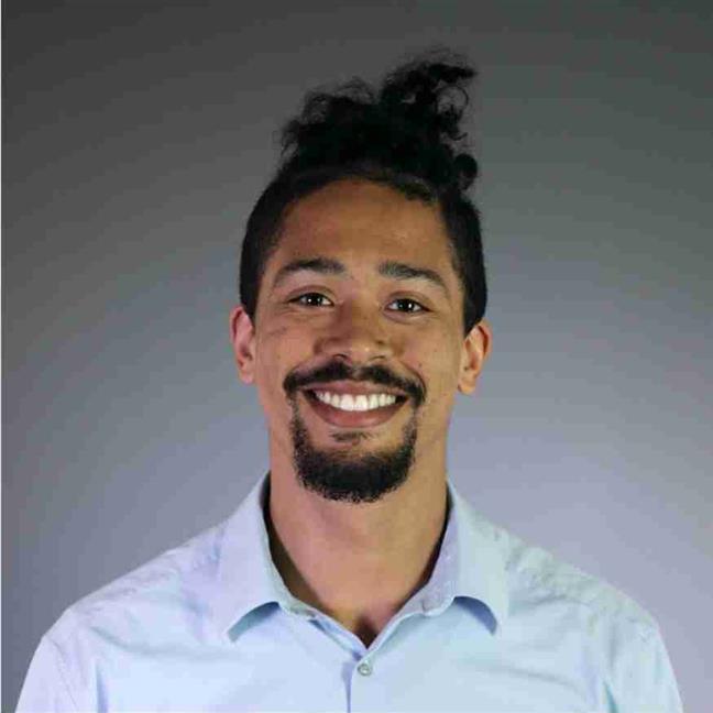 A person with a beard and a bun

Description automatically generated