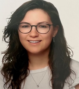 A person with long hair wearing glasses

Description automatically generated