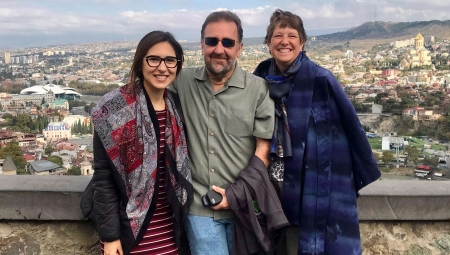 Brian and Sheila Green, with Georgian Fellow, Veka, posing together with views of Tblisi in the background