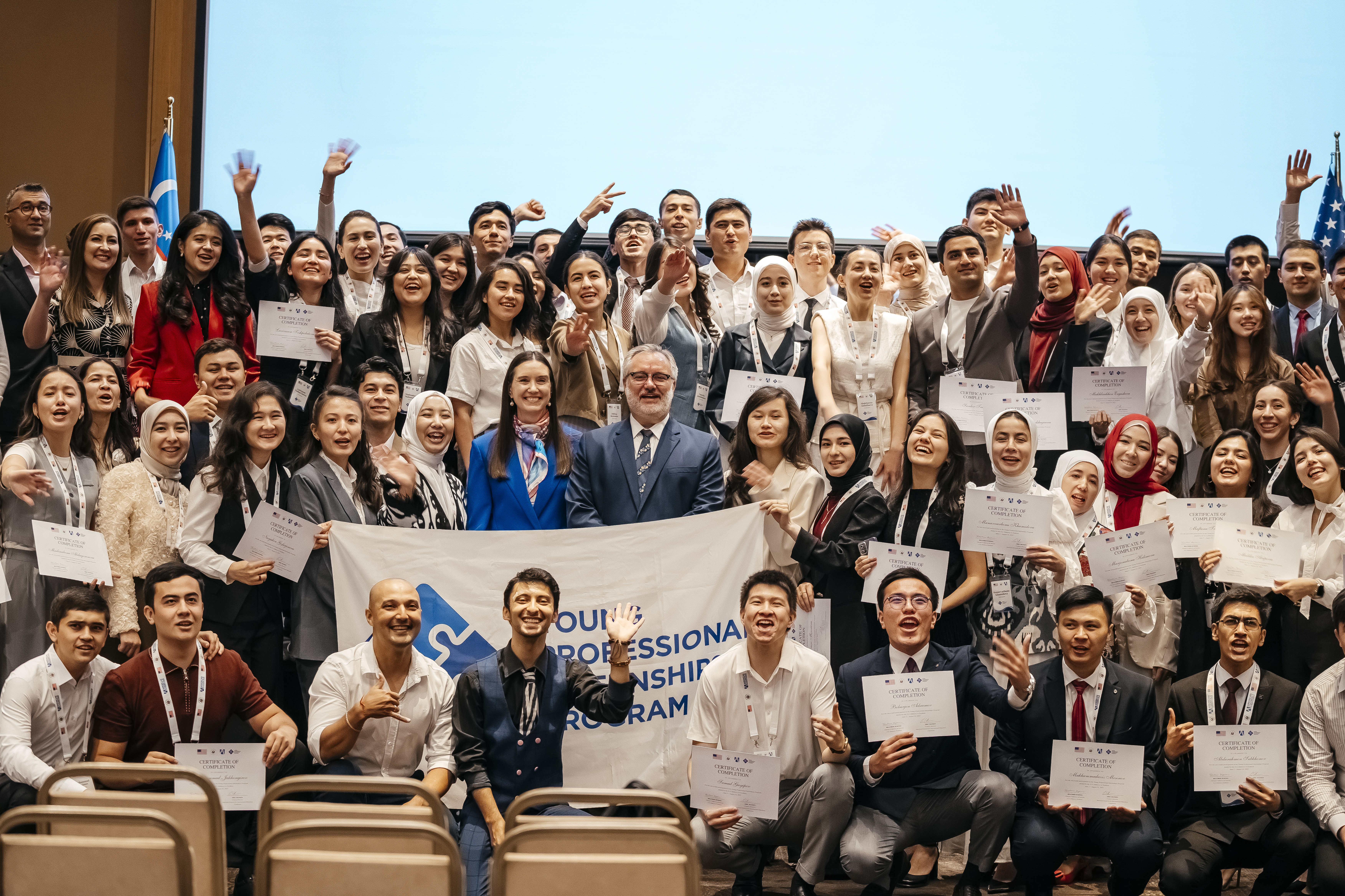 YPIP 2025 Summer Closing Celebration Group Photo: Participants celebrate with certificates and YPIP flag