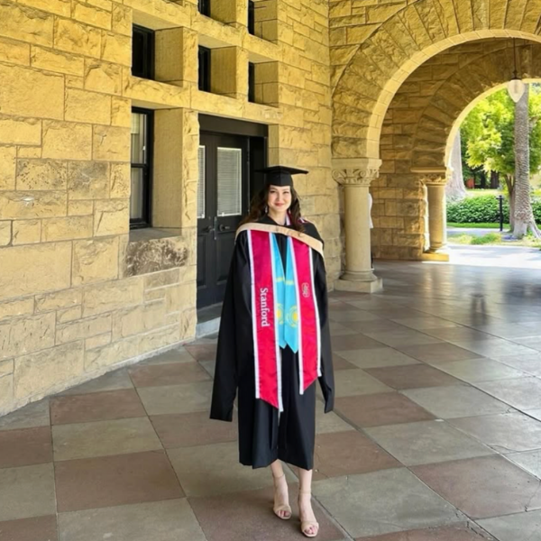 Naza at Stanford Graduation wearing Cap and Gown and Kazakhstan Flag